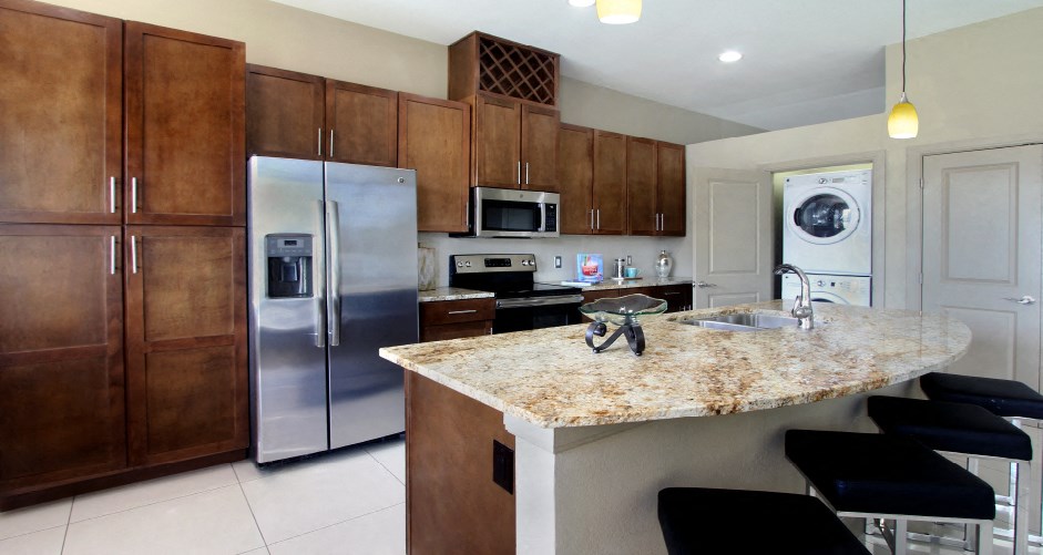 Luxury apartments with spacious kitchen, granite countertops, stainless steel appliances, built-in wine rack, kitchen island, front-loading washer and dryer and porcelain tile floor at Bellemeade Apartments in west Des Moines