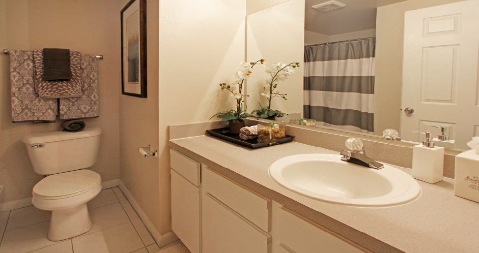 Spacious bathroom with lots of cabinet space, soaking tub and shower, and porcelain tile floors at Breckenridge Apartments in Omaha, Nebraska