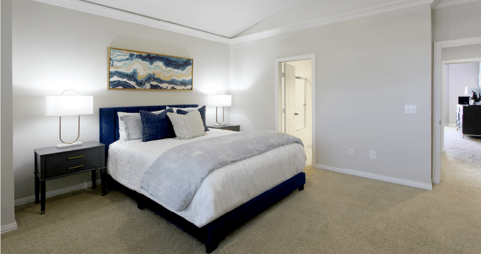 Huge bedroom, spacious bedroom with vaulted ceiling, ceiling fan, walk-in closet, and attached bathroom at Tuscany Row Townhomes in Houston.