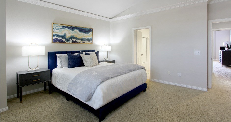 Huge bedroom, spacious bedroom with vaulted ceiling, ceiling fan, walk-in closet, and attached bathroom at Tuscany Villas Townhomes in Houston.