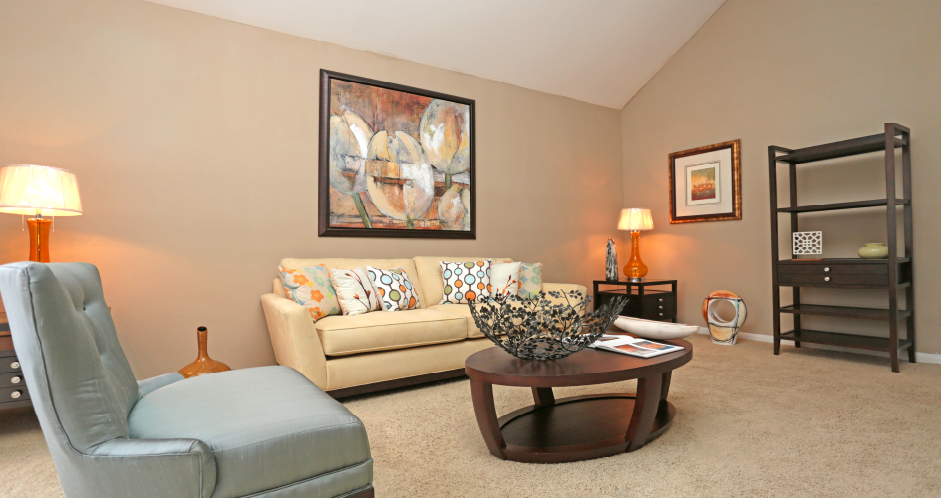 Spacious floor plan with vaulted ceiling, woodburning fireplace, and oversized windows at Woodlake on the Bayou Apartments in Houston.