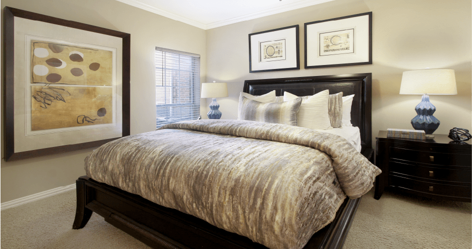 Spacious bedroom with walk-in closet and ceiling fan at Tuscany Lane Apartments in Houston.