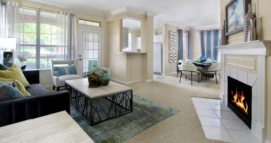 Luxury apartments with spacious open floor plan, woodburning fireplace, and oversized windows at Saddlebrook apartments in Urbandale, Iowa