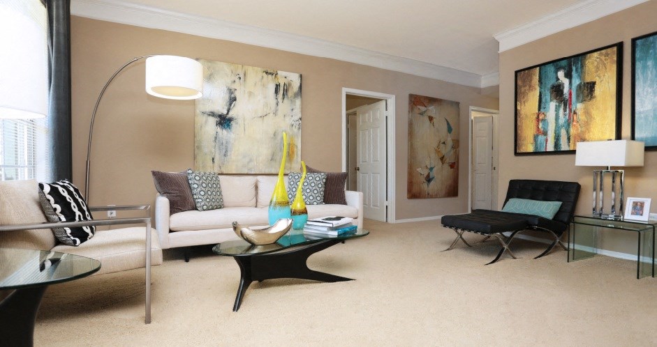 Spacious living room with crown molding and oversized windows at Village on the Parkway Apartments in Houston, Texas
