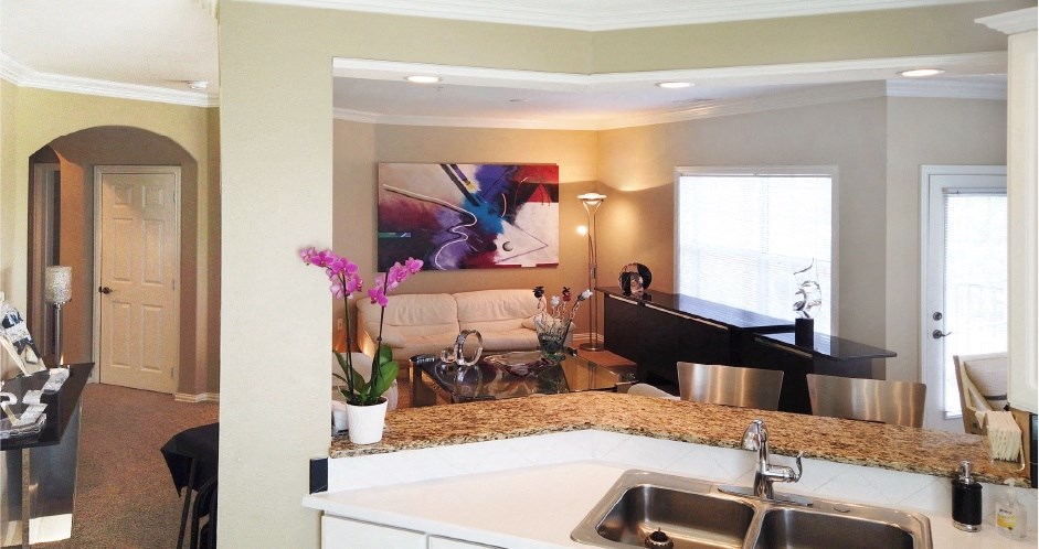 Spacious luxury apartments with 9-foot ceilings, granite breakfast bars, oversized windows and white kitchen cabinets at RidgeGate Apartments in Minnetonka, Minnesota