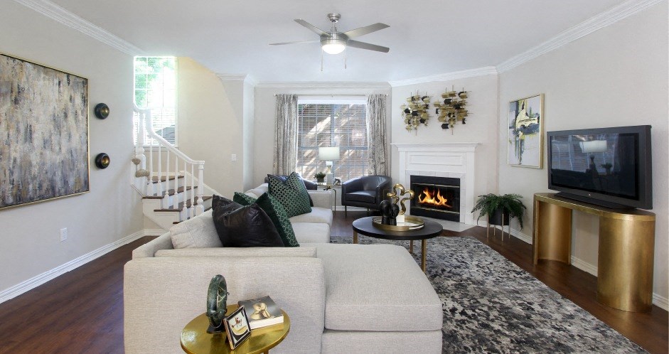 Spacious living room with wood-burning fireplace, wood plank flooring, huge living room at Tuscany Villas Townhomes in Houston.