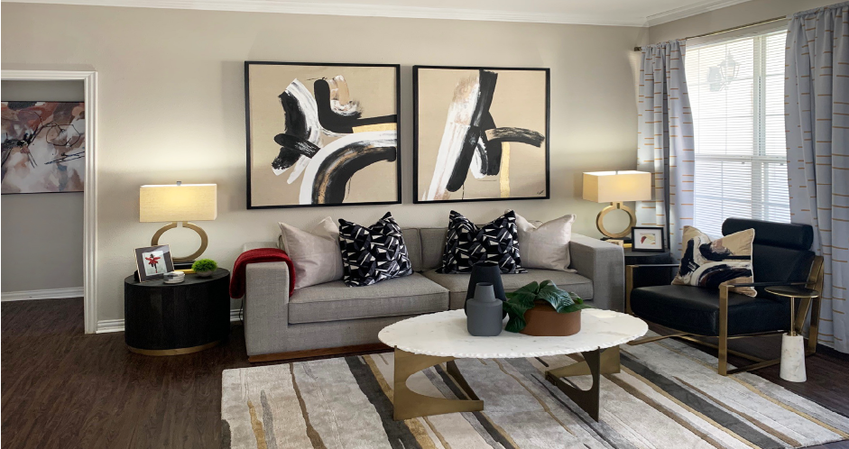 Luxury apartments with spacious living room, oversized windows, and plank wood floors at Saddlebrook apartments in Urbandale Iowa