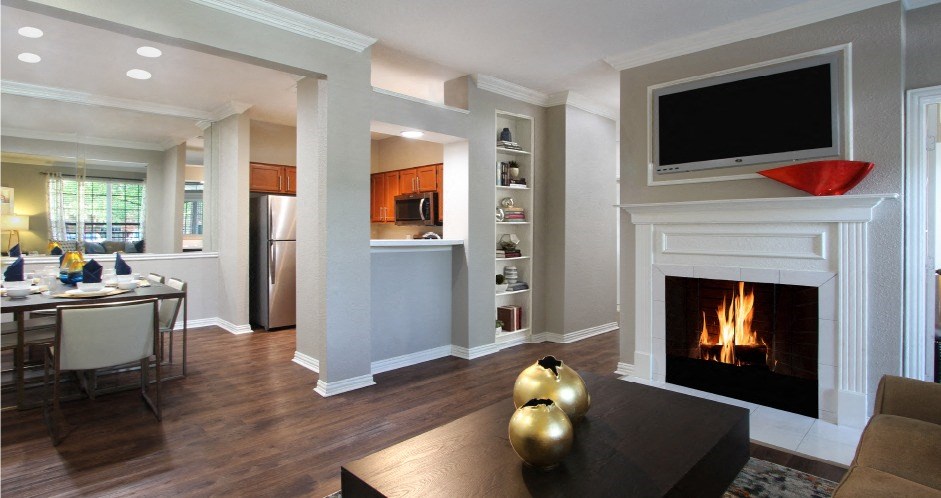 Luxury apartments with wood grain plank floors, built-in shelves, dining room, u-shaped kitchen, 9-foot ceilings, and woodburning fireplace at Lenox Village Apartments in Lincoln, Nebraska