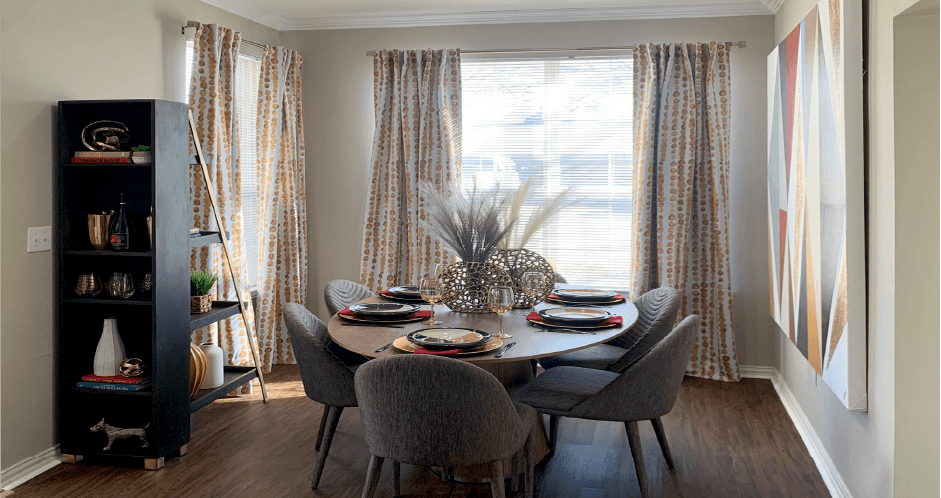 Luxury apartments with spacious dining room, oversized windows, and plank wood floors at Saddlebrook apartments in Urbandale Iowa