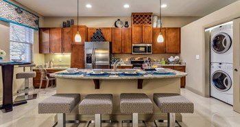 Luxury apartments next to the Galleria in Dallas with spacious floor plan, granite countertops, stainless steel appliances, built-in wine rack, kitchen island, front-loading washer and dryer and porcelain tile floor at Villa Piana Apartments in Dallas - Photo Gallery 32