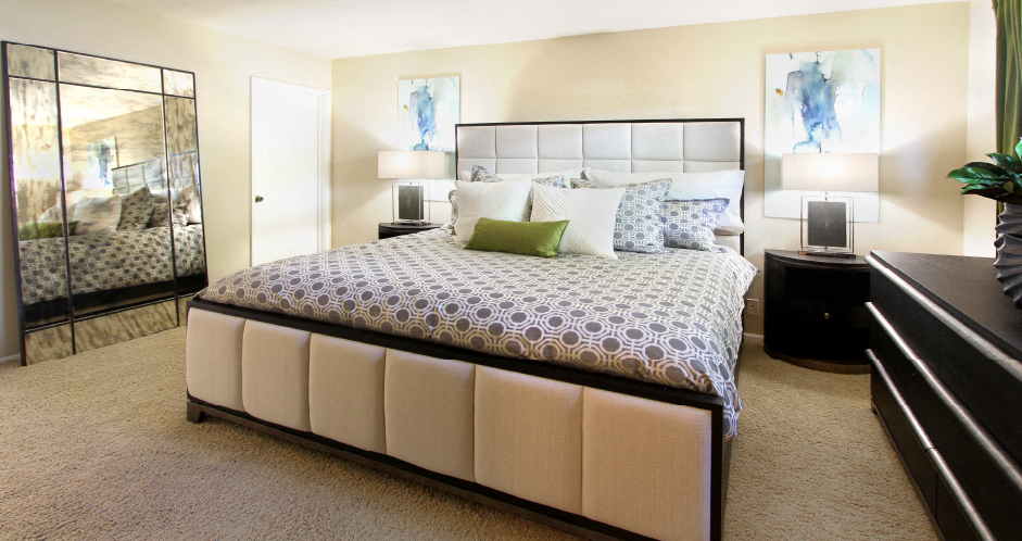 Spacious master bedroom with attached master bathroom and walk-in closet at Alpine Village Apartments in La Vista, Nebraska