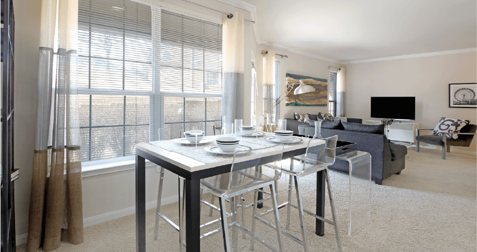 Apartments in southwest Omaha with open floor plan, open layout, spacious apartment, spacious living room, spacious dining room, lots of natural light, and oversized windows at Breckenridge Apartments in Omaha, Nebraska