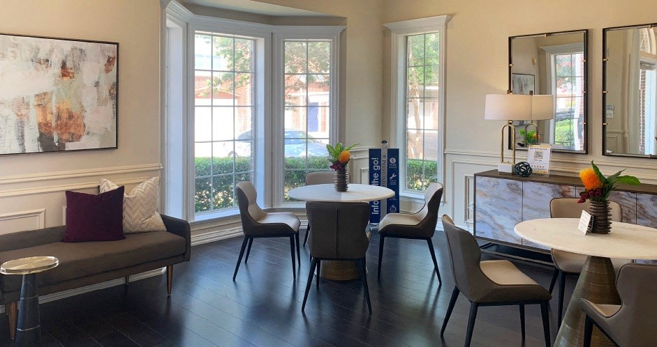 a living room with a table and chairs