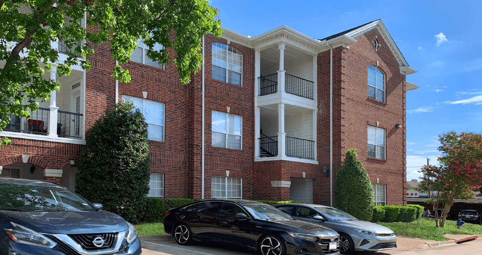 Gated community near the Galleria with brick exteriors, lush landscaping, covered parking, and detached garages.