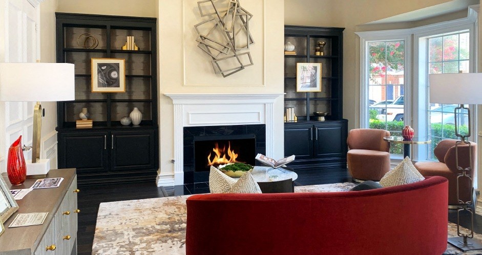 a living room with a red couch and a fireplace