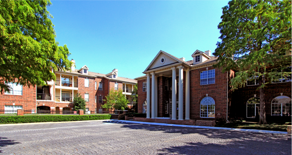 Gated apartment community near the Galleria in Dallas with luxury clubhouse and resident lounge, free wi-fi, meeting room, red brick exteriors, and beautiful landscaping at The Dorchester Apartments