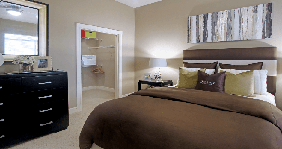 Master bedroom with spacious walk-in closet at Delante Apartments in Irving Texas