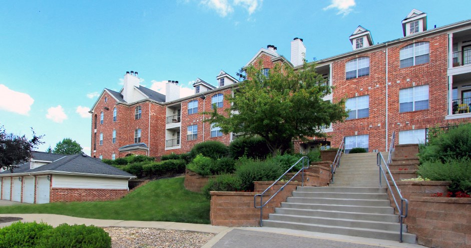 Luxury apartments with red brick exteriors, garages, and lush landscaping at TurtleCreek apartments in West Des Moines, Iowa