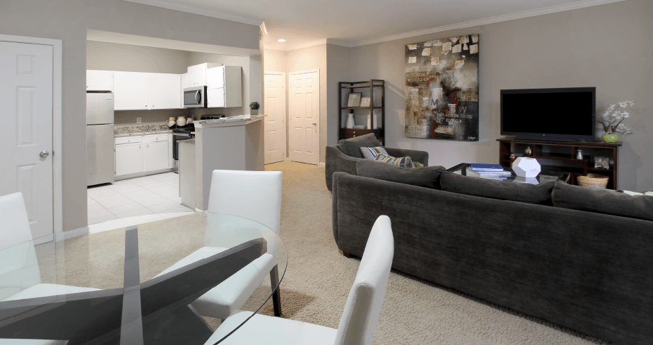 Apartments in southwest Omaha with spacious layout, spacious living room, spacious dining room, granite countertops, white kitchen cabinets, and stainless-steel appliances at Breckenridge Apartments in southwest Omaha, Nebraska