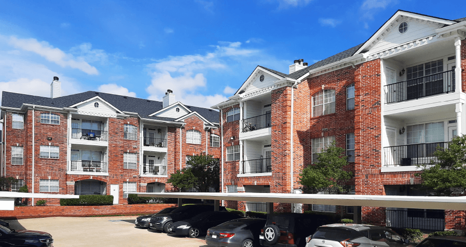 Gated luxury apartment community in north Dallas with red brick exteriors at The Saxony Apartments