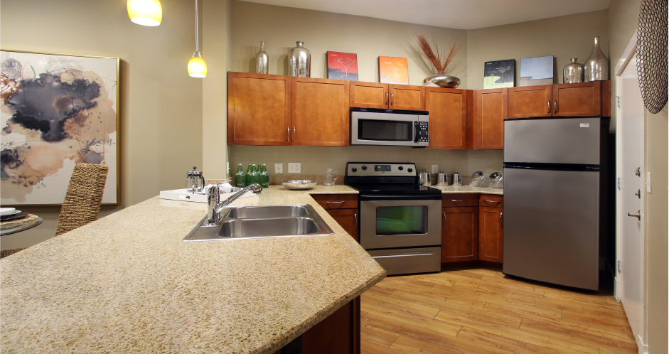 Luxury apartments with hardwood floors, granite countertops, stainless steel appliances, and honey-brown toned cabinets in the Las Colinas area of Irving, Texas