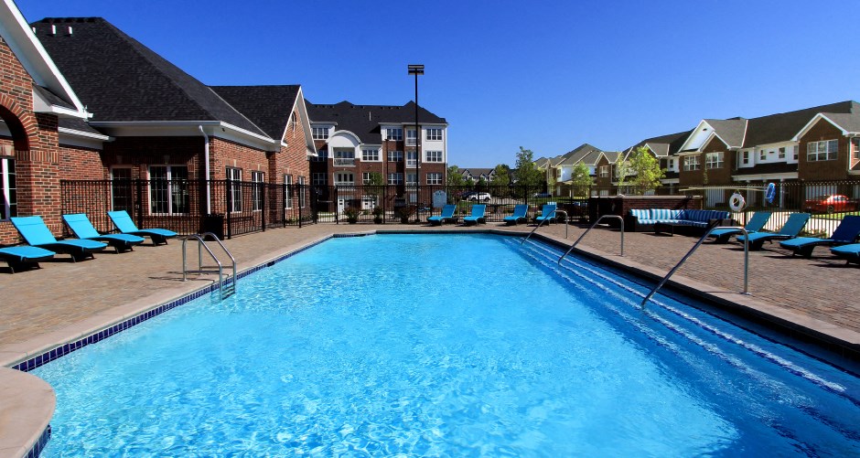 Luxury apartments with swimming pool, poolside lounges, grilling station, ping-pong table and brick exteriors at Bellemeade Apartments in west Des Moines