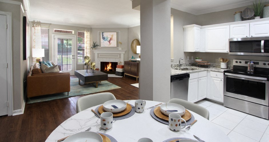 Luxury apartments with plank wood floors, woodburning fireplace, French door, white cabinets, stainless steel appliances, and granite countertops at TurtleCreek apartments in West Des Moines, Iowa