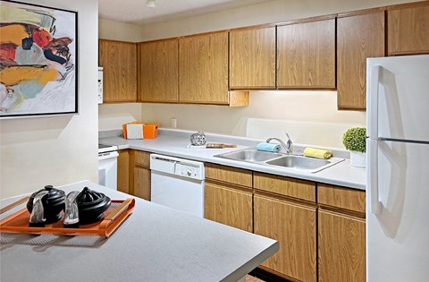 Kitchen with wood cabinets and lots of cabinet space at Claremont Apartments in Minnetonka, Minnesota