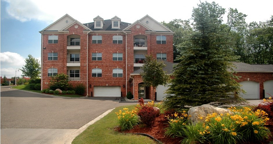 Luxury apartments with red brick exterior, garages, and scenic views in Minnetonka, Minnesota