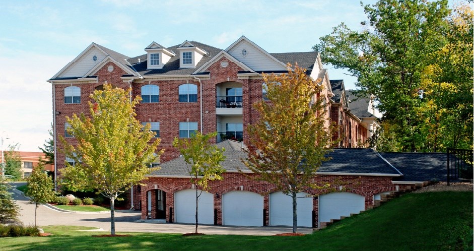 Luxury apartments with red brick exterior, garages, and scenic views in Minnetonka, Minnesota