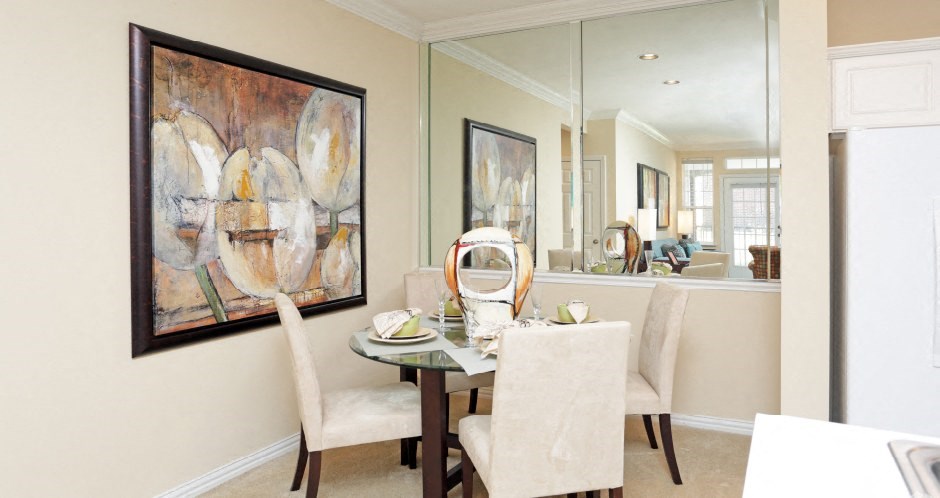 Luxury apartments with spacious dining room and mirror accent wall at Rockledge Oaks Apartments in Lincoln, Nebraska