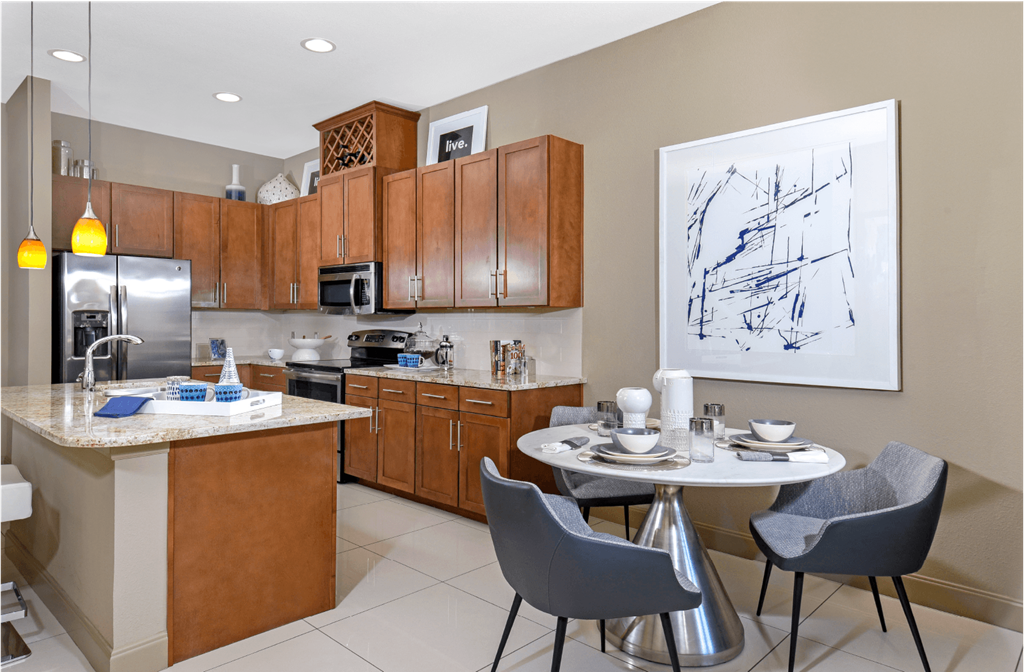 Luxury apartments in Bloomington Minnesota with granite countertops, stainless steel appliances, built-in wine rack, kitchen island, and porcelain tile floor at Luxembourg Apartments