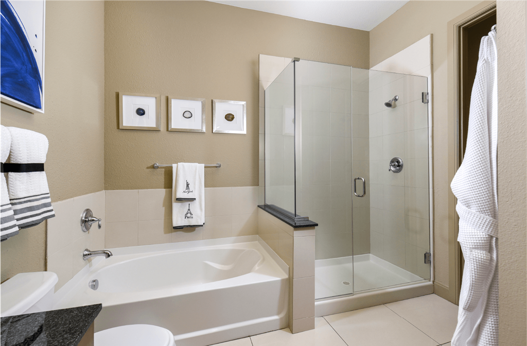 Luxury bathroom with granite countertops, glass shower and separate soaking tub at Luxembourg Apartments in Bloomington Minnesota