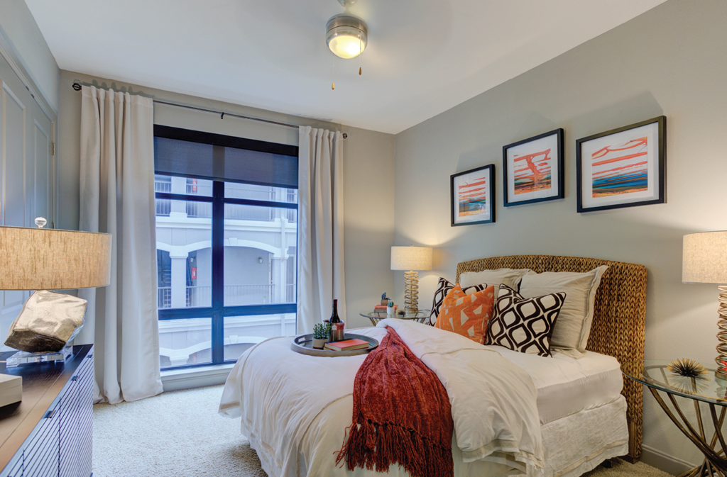 Spacious bedroom with 11-foot ceilings and walk-in closet at Le Palais Apartments in Houston.