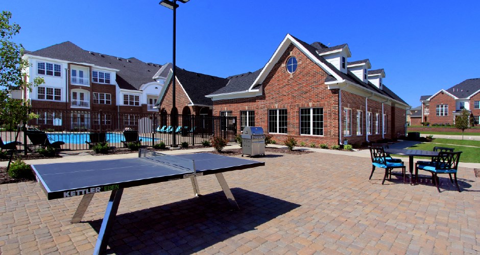 Luxury apartments with swimming pool, poolside lounges, grilling station, ping-pong table and brick exteriors at Bellemeade Apartments in west Des Moines