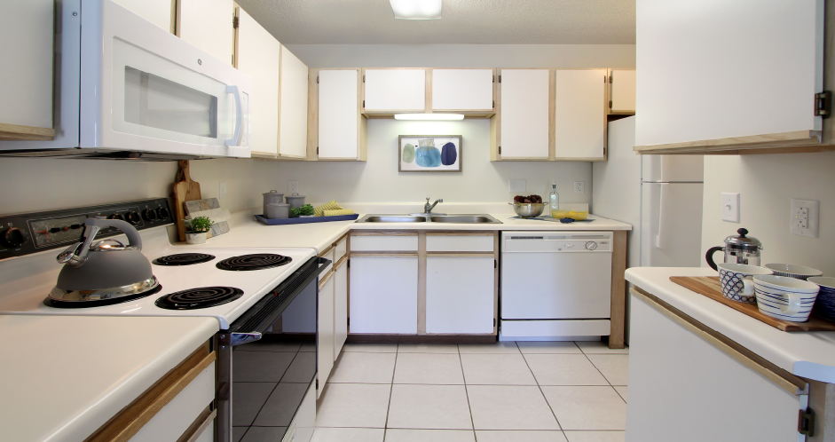 Spacious kitchen with extra cabinet space, extra counter space, tiled floors, bright white kitchen, at Tanglewood Apartments in Lincoln, Nebraska
