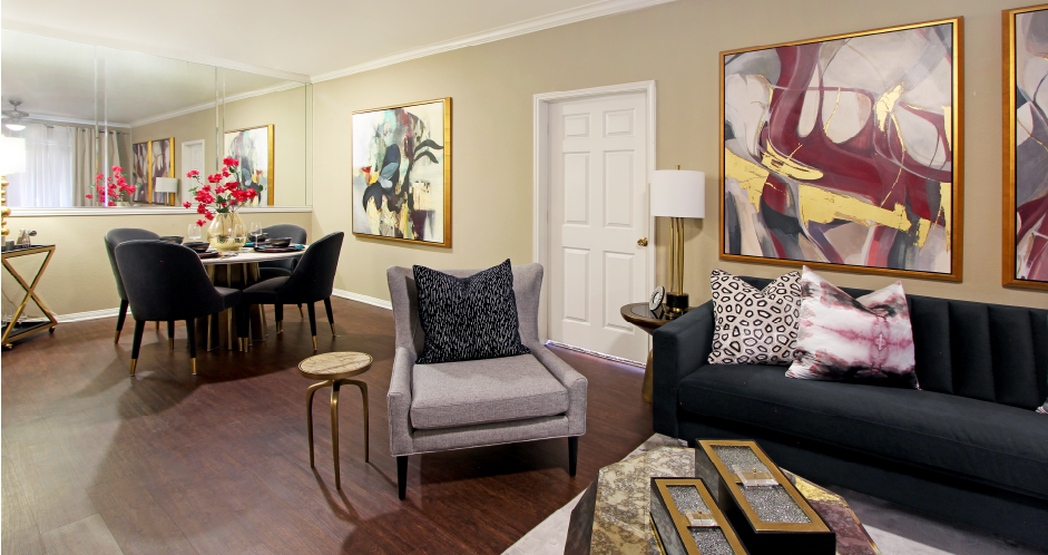Luxury apartments with spacious dining room, wood plank floors, breakfast bar, mirror accent wall, and 9-foot ceilings at Kensington Square Apartments.