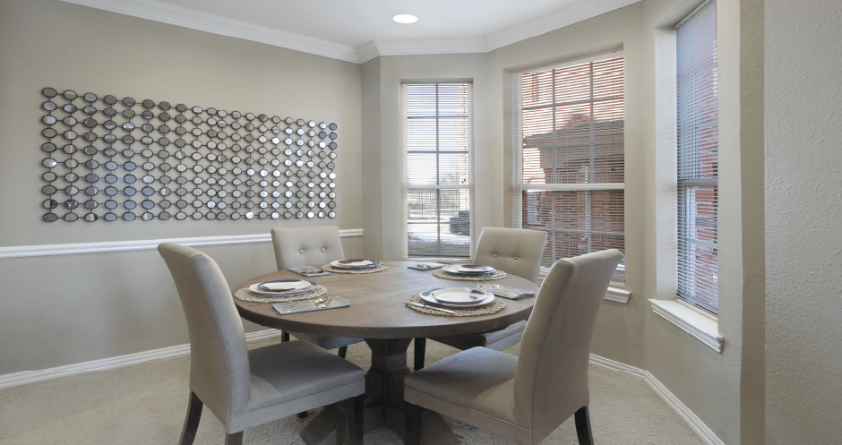 Luxury apartments in central Omaha with spacious dining room with bay windows, oversized windows, and crown molding at The Biltmore Apartments in Omaha, Nebraska