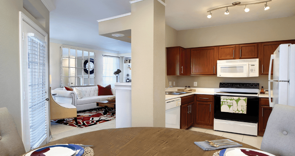 Spacious luxury apartments with built-in shelves, spacious dining room, u-shaped kitchen, rich brown toned cabinets, crown molding, French door and oversized windows at The Biltmore Apartments in Omaha, Nebraska