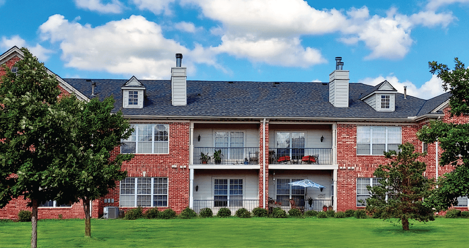 Luxury apartments in central Omaha with golf course views, scenic views, lots of trees, red brick exterior, lush landscaping, beautiful landscaping, and spacious balconies at The Biltmore Apartments