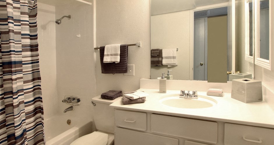 Spacious bright white bathroom at Briarwood Apartments in Houston.