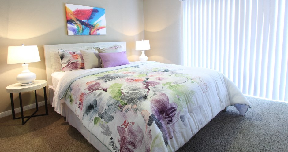 Spacious bedroom with ceiling fan and walk-in closet at Briarwood Apartments in Houston.