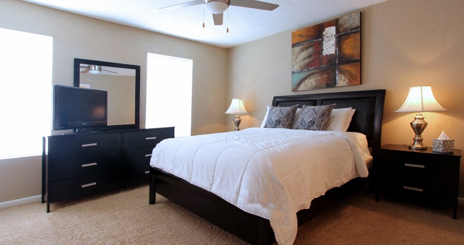 Spacious bedroom with ceiling fan and walk-in closet at Briarwood Apartments in Houston.
