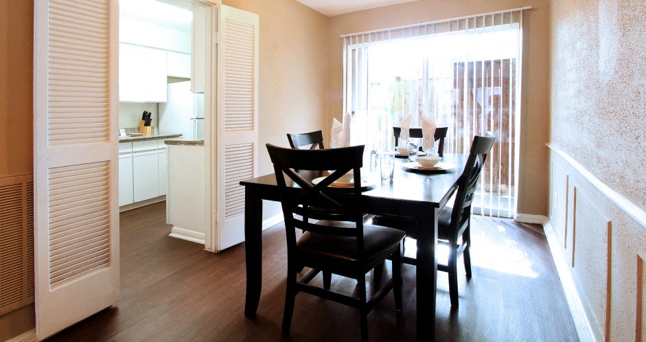 Spacious dining room with hardwood floors at Briarwood apartments in Houston.