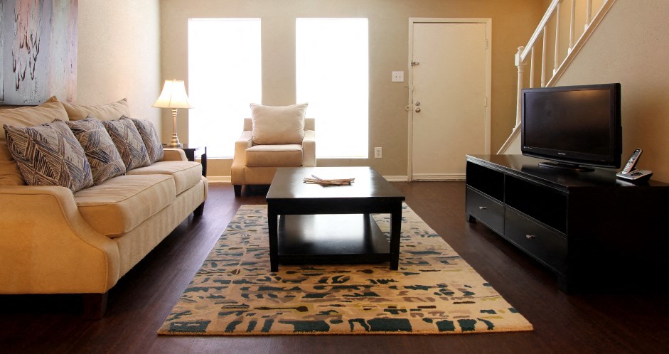Spacious living room, spacious townhome with hardwood floors, and private entries at Briarwood Apartments in Houston.