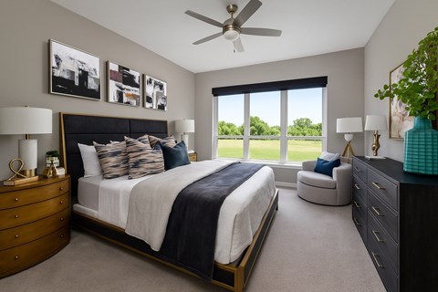 a bedroom with a bed and a large window