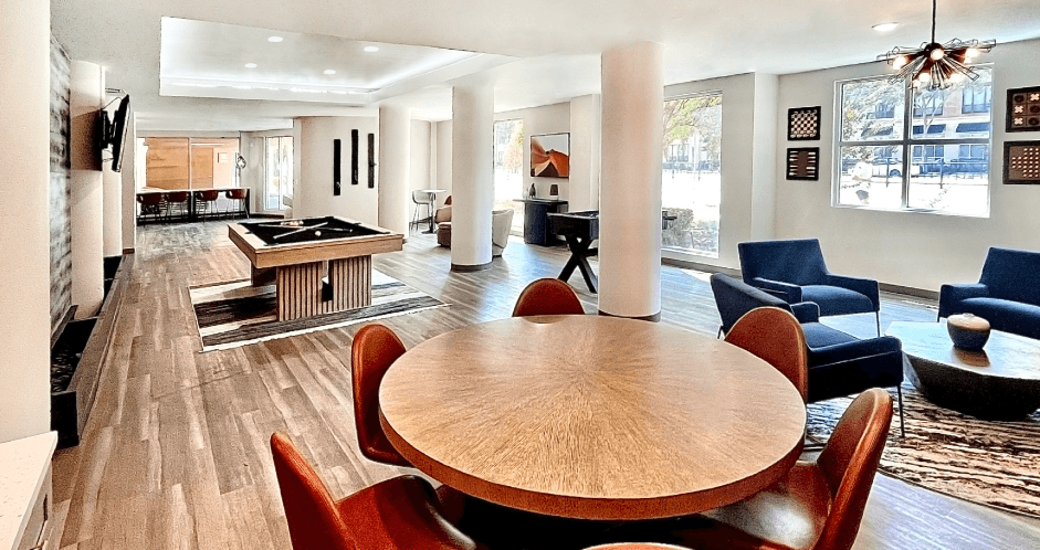 Spacious modern resident lounge with pool table, sitting areas, and wi-fi at Delante Apartments in Irvington, texas