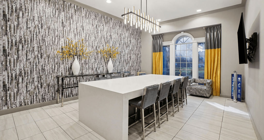 A dining room with a white table and chairs.