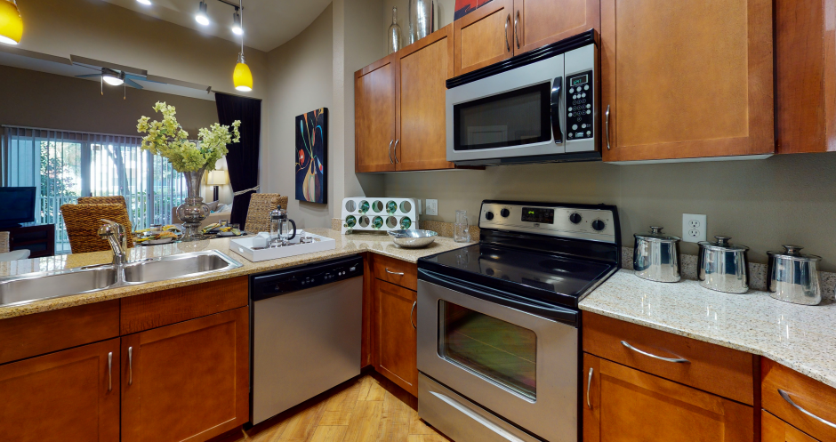 Luxury apartments with hardwood floors, granite countertops, stainless steel appliances, and honey-brown toned cabinets in the Las Colinas area of Irving, Texas