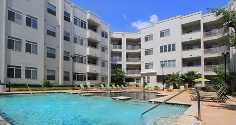 A swimming pool in front of apartment buildings.